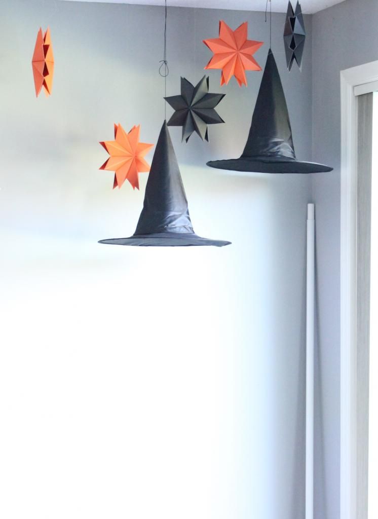 witch hats hanging in the dining room for Halloween